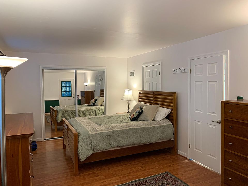The bedroom has a large closet and two dressers.