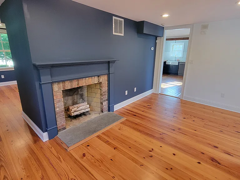Dining room w/ fireplace (it works), with view to kitchen (right) and hall to living room (left)