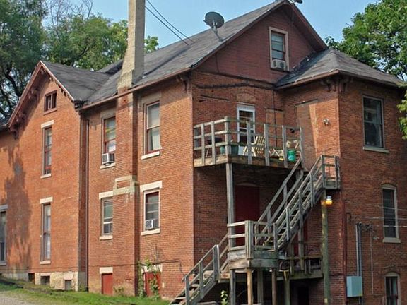 Back view of 726 E. High St. The apartment listed is up the back stairs with its own private deck. We call it "The Tree House" apartment.