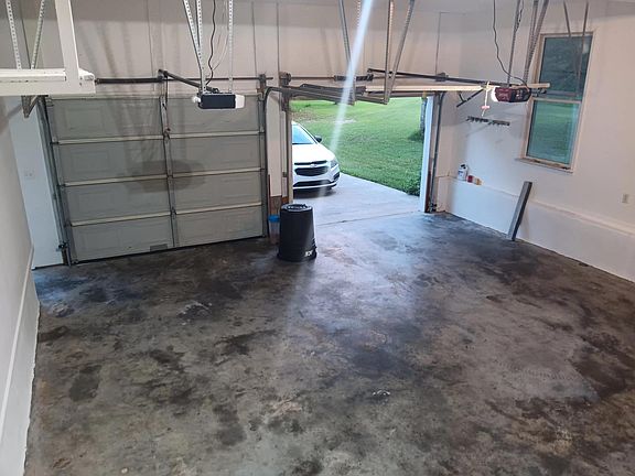 Double car garage with side door just around nook on the left.