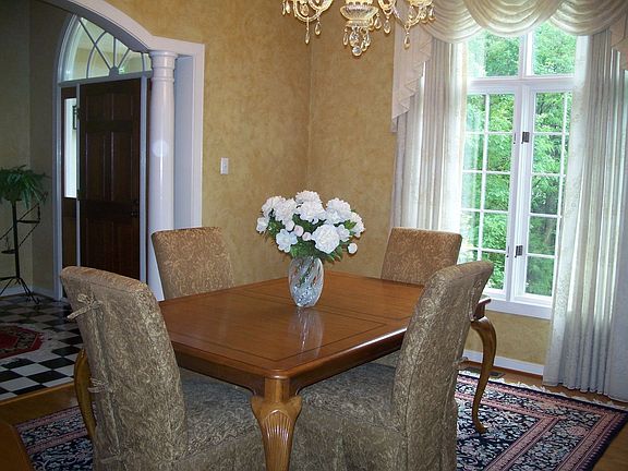 Tray ceiling & window are nice touches in this stunning dining room.