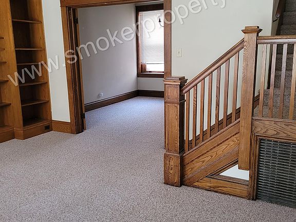 Living room with built in book shelves and beautiful woodwork