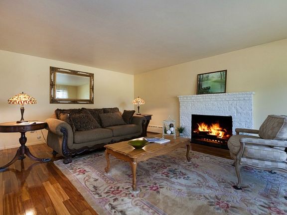 Very large living room gets lots of natural western light. Woodburning fireplace for the cool seasons. Gorgeous cherry wood floors and a new granite hearthstone.