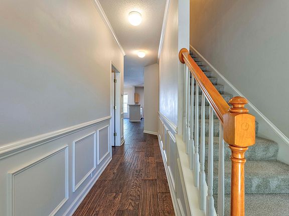 Entry way with wood-look tile throughout the first floor.