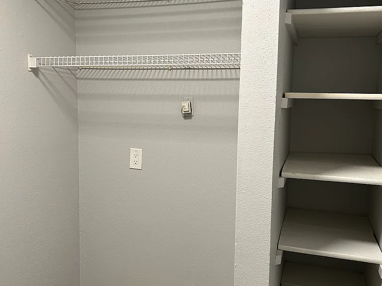 Other side of the laundry room with a pantry.