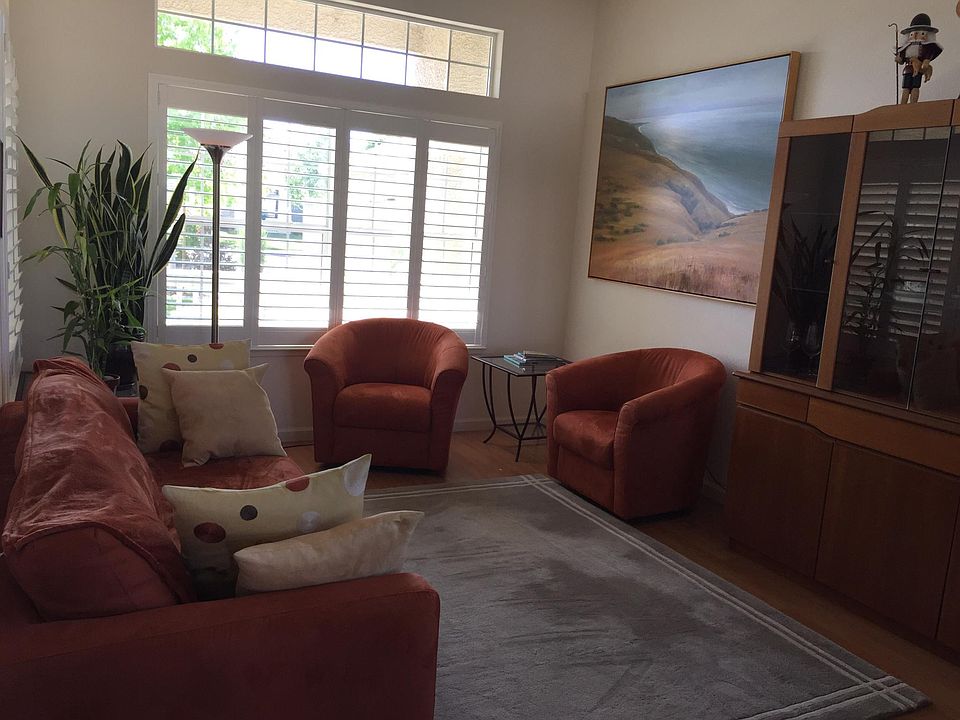 Living room looks to front yard. Home faces east.