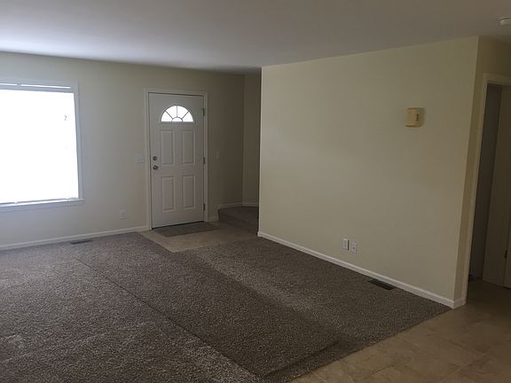 View from kitchen to living room front door and stairway