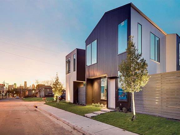 Front of Ascend Modern Homes in East Village Dallas by Lardner Group Development with downtown horizon.