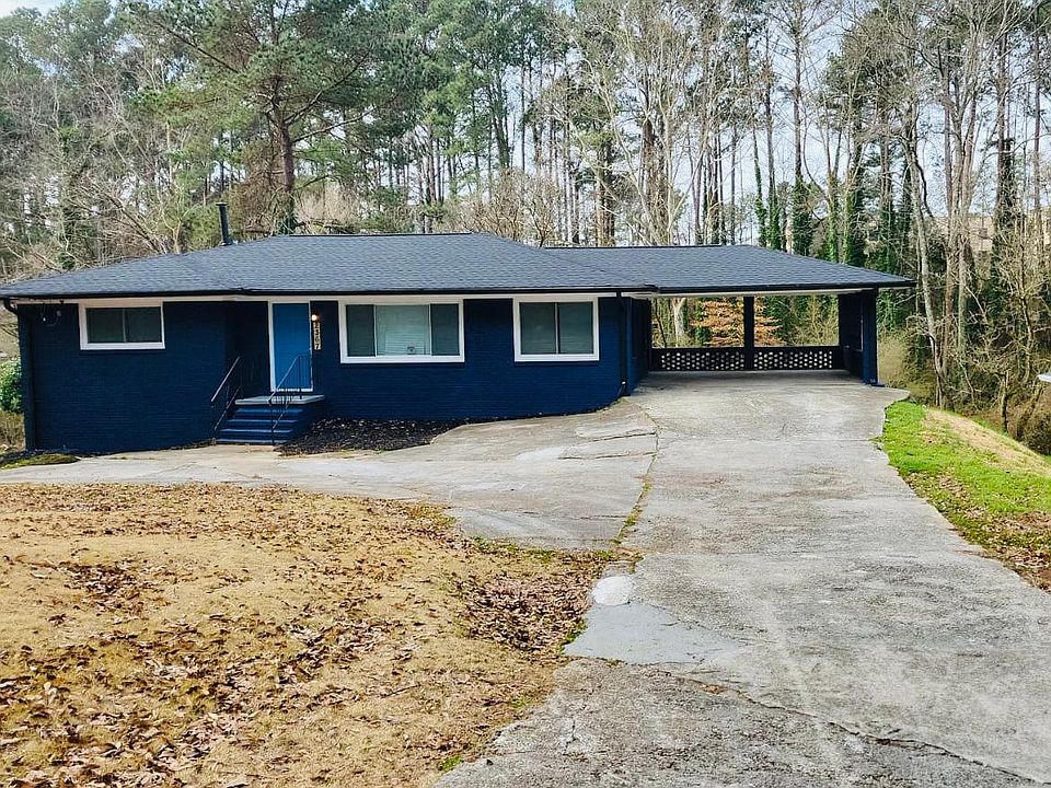 Large driveway, two car carport, new roof and gutters