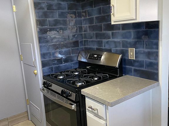 Totally remodeled kitchen, with ceramic tile backslpash throughout.