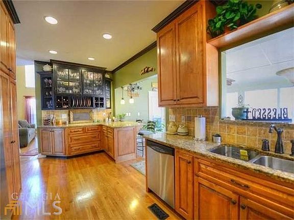 Fabulous renovated Chef's Kitchen features custom made cabinets with several glass doors, crown mold