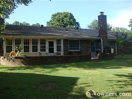 Rear of home with view of sunroom