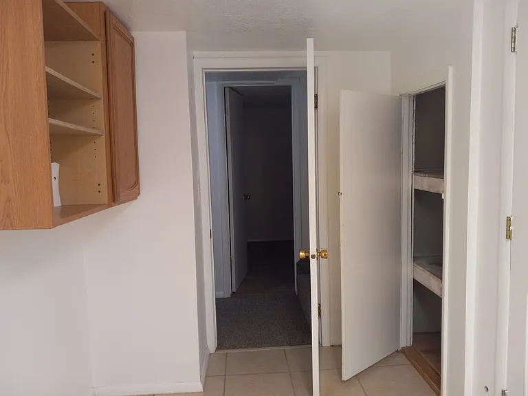 View #2 of laundry room. Ample cabinet storage. Deep linen closet. Doorway pictured.