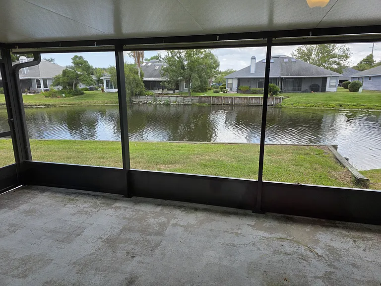 Screened in backporch with a lake view