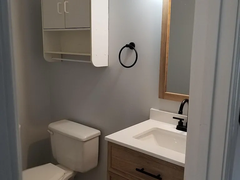 Half bath located off of living room and kitchen.