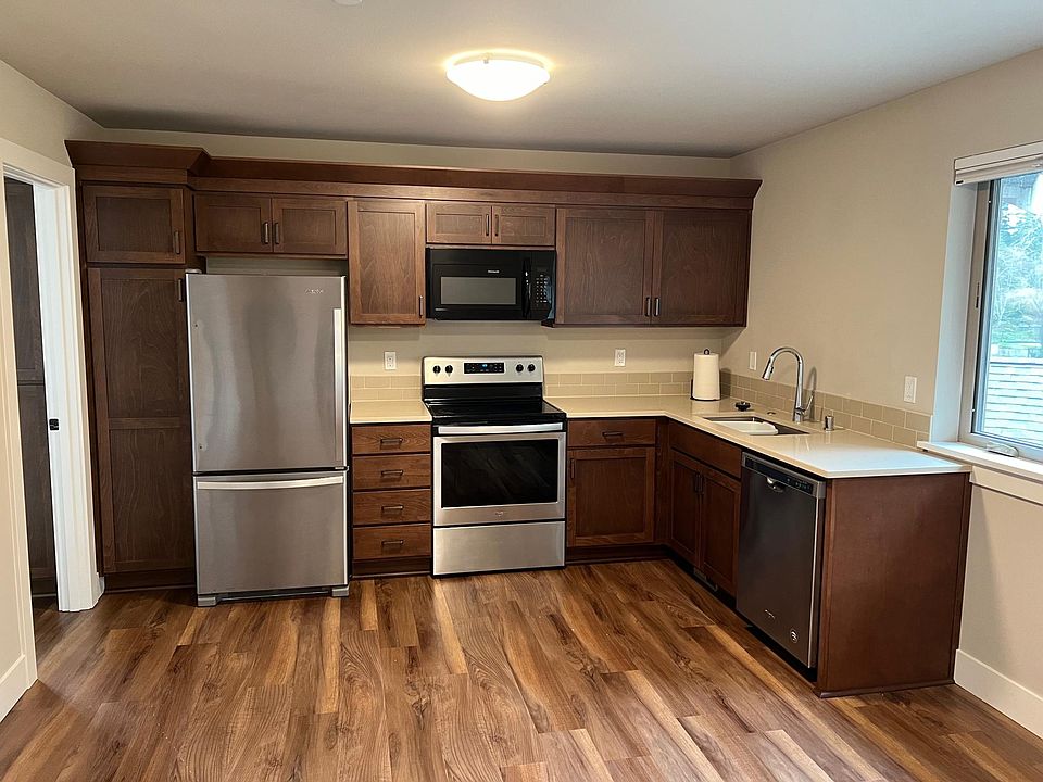 Full kitchen with stainless steel appliances and quartz countertops