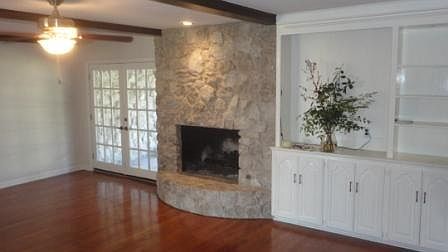 Living room w/ gas log fireplace, patio doors