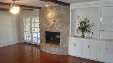 Living room w/ gas log fireplace, patio doors
