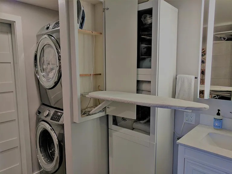 Master Bath: Built-in ironing board & linen storage cabinet
