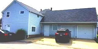 Parking garage on right comes with unit as well as space in front of it.