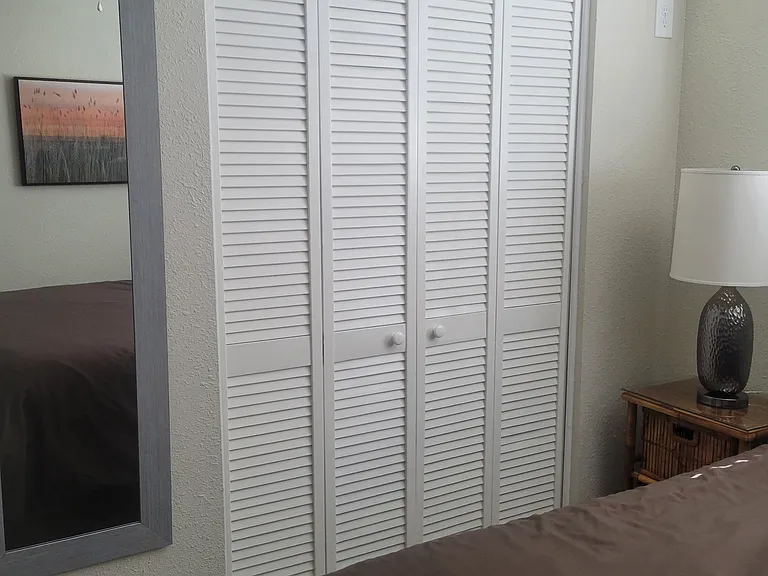 Closet doors and mirror in 2nd bedroom with Queen bed.