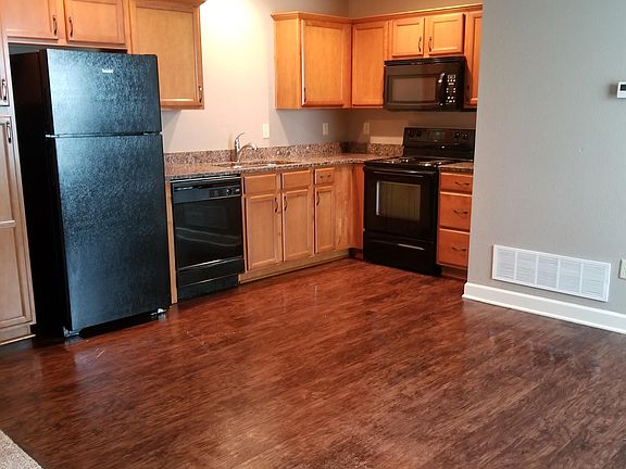 Kitchen with granite and vinyl plank flooring