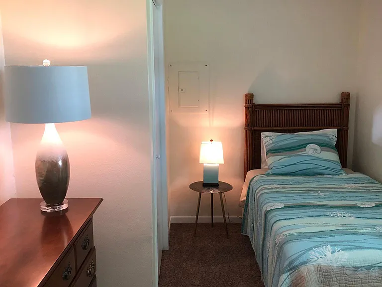 Bedroom #3: (2) Twin beds, dresser with mirror/hairdryer, ceiling fan, towel hooks, and closet.