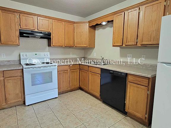Kitchen with oven, dishwasher, and refrigerator