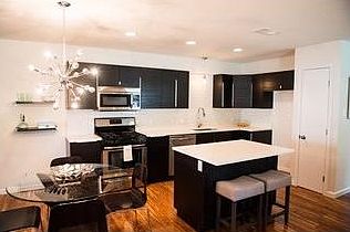 quartz counter tops and stainless steel appliances in kitchen