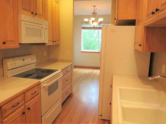 More kitchen - with a view into the dining room. Note: Unit has. a gas stove and a gas hookup for the dryer.