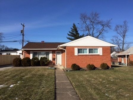 Brick home with a large front yard.
