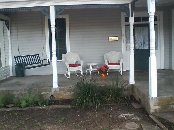 Charming covered front porch with swing