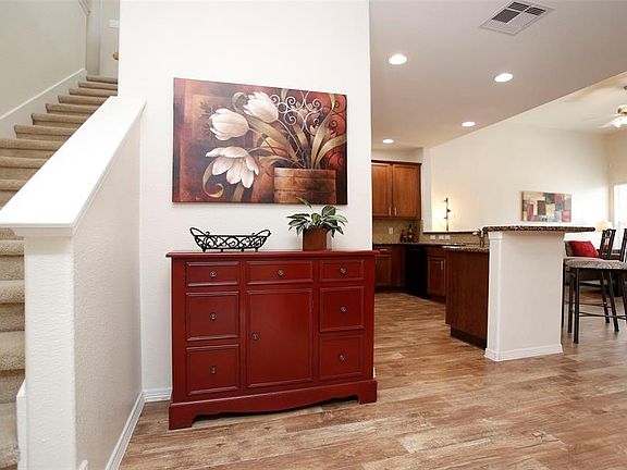 Step inside and you will be WOWED. Stunning hardwood tile flooring in the inviting living and dining areas, open kitchen with breakfast bar and lots of windows. Great for entertaining!