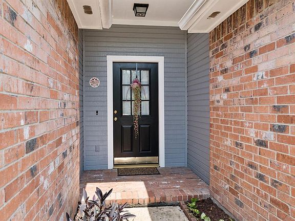 Greet guests in the charming porch area.