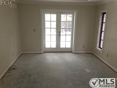 Master bedroom with french doors to pool