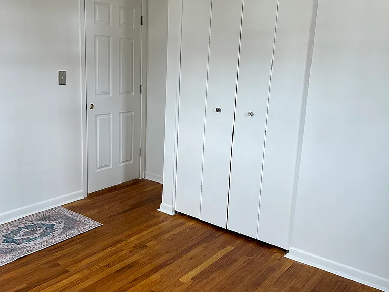 2nd bedroom with original hardwood floor and large closet.