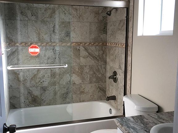 Private bath off one of bedrooms, all bathrooms have bathtubs, granite countertops, and exhaust fans