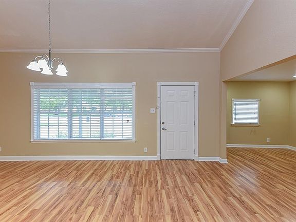 Large open floorplan with wood like floors and fresh paint.