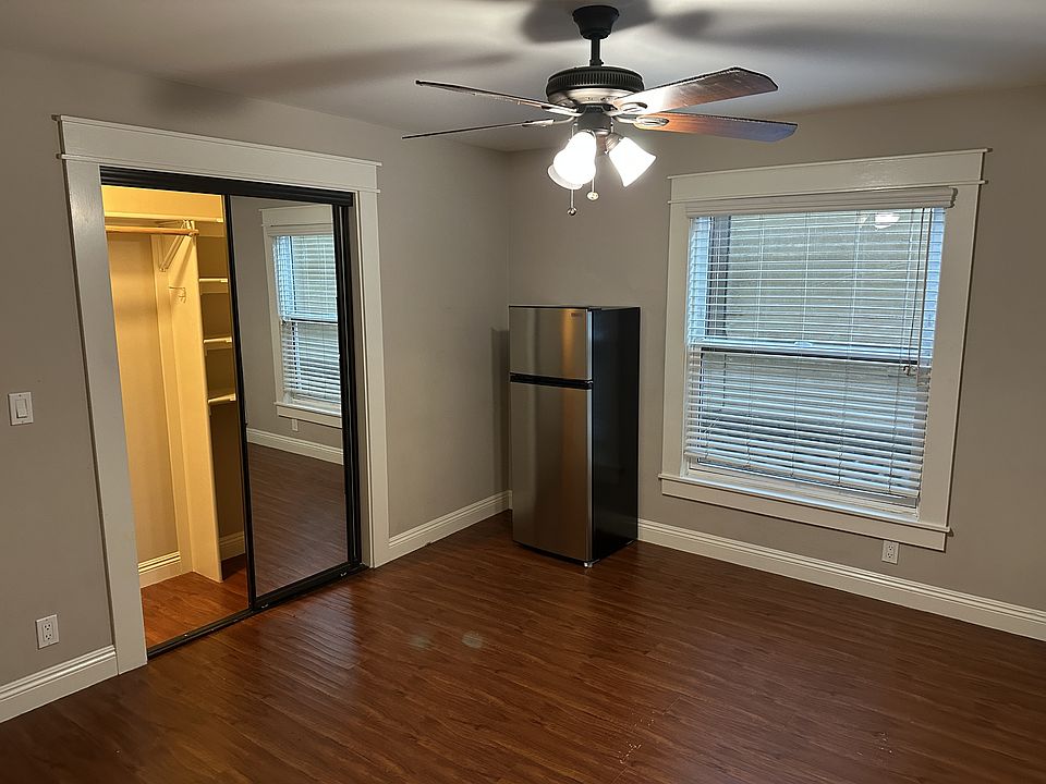 Closet with mirrored doors, refrigerator.