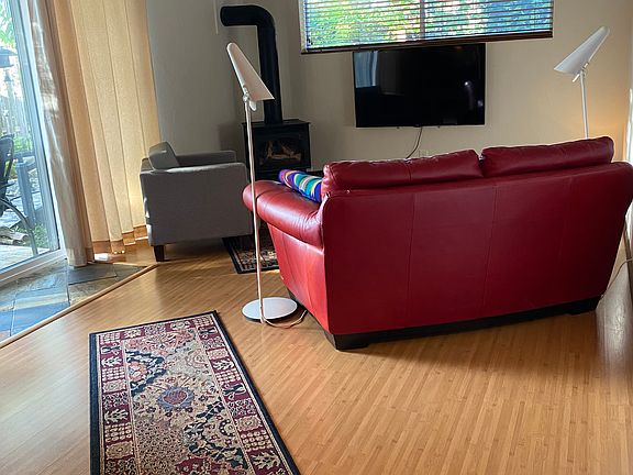 Flat screen TV in living room and remote controlled fireplace in the corner