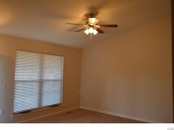 Vaulted living room and double window in front of home