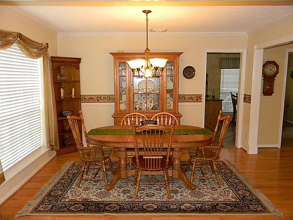 Dining offers crown & chair-rail molding, 2 inch blinds, hardwood floors and an updated light fixture.