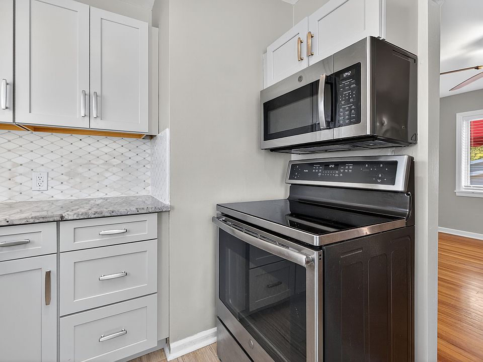 Kitchen with 5-burner stove, oven, and microwave