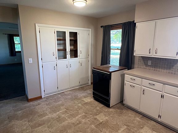 Kitchen and dining room combo. Many shelves for storage.