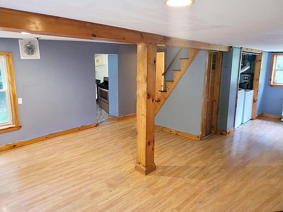 First floor - large open plan area with exposed wooden beam accents