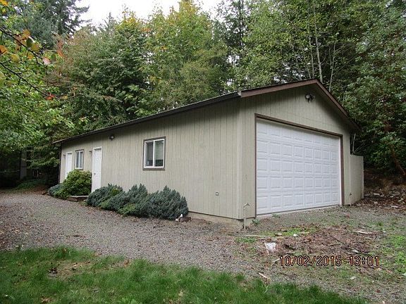 Double car garage located behind the house. The doors seen at left open to two separate rooms.