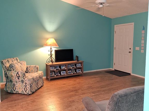 Living room has a chair, manual recliner & sofa.