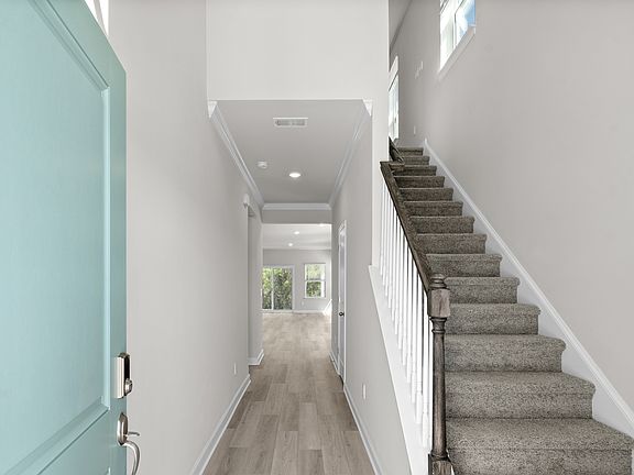 The stairs lead to a second floor with flexible work area.