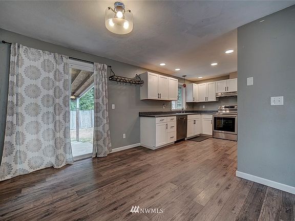 Open kitchen has brand new stainless appliances and cabinets!