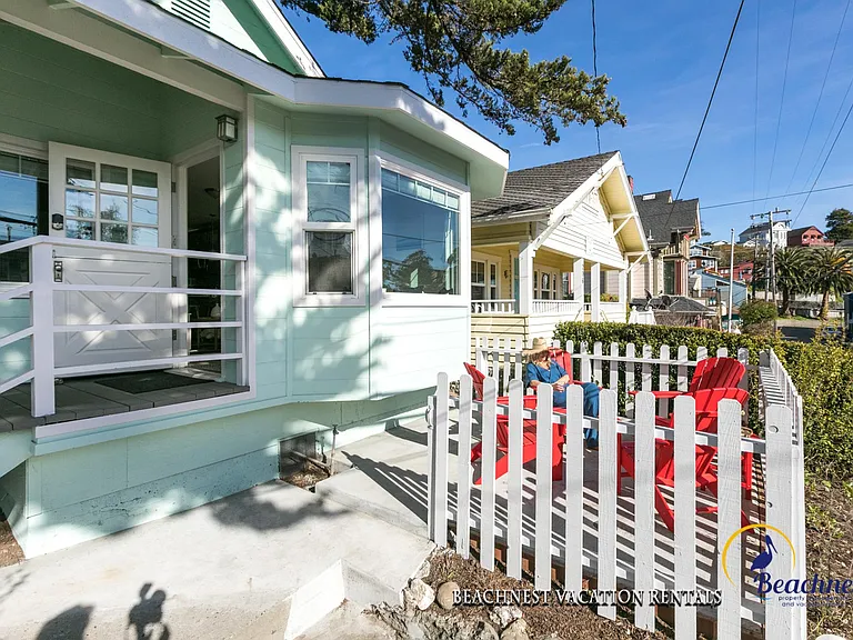 Front of the house features adirondack chairs for lounging.